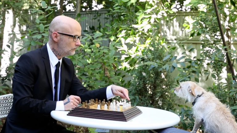 Moby plays chess with Bagel the talking dog in his new film. Image: Punk Rock Vegan Movie