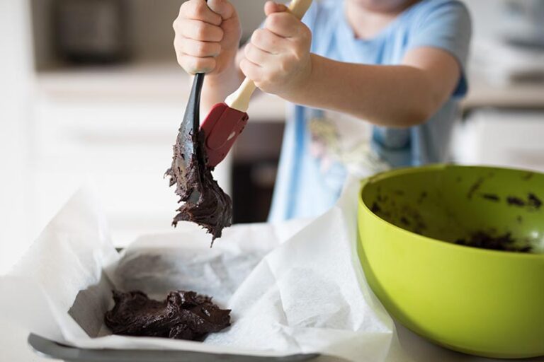 Choosing a smaller pan will yield thicker brownies with a gooey texture. Photo © LightItUp via Adobe Stock