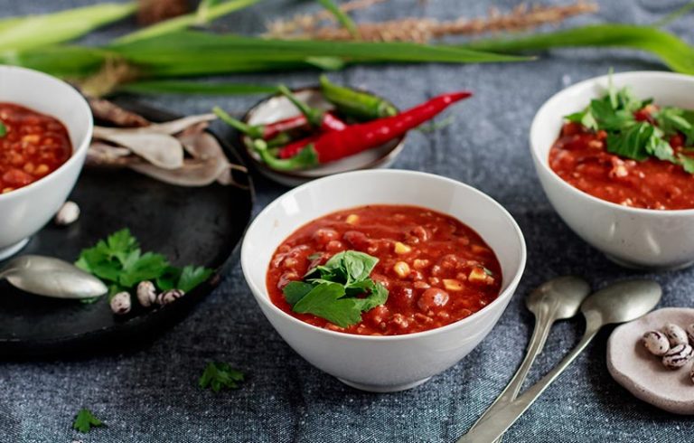 Hearty stews filled with beans, potatoes served with rice are a healthy and affordable way to pack protein into your meals. Image: Viktorné Lupaneszku via Getty