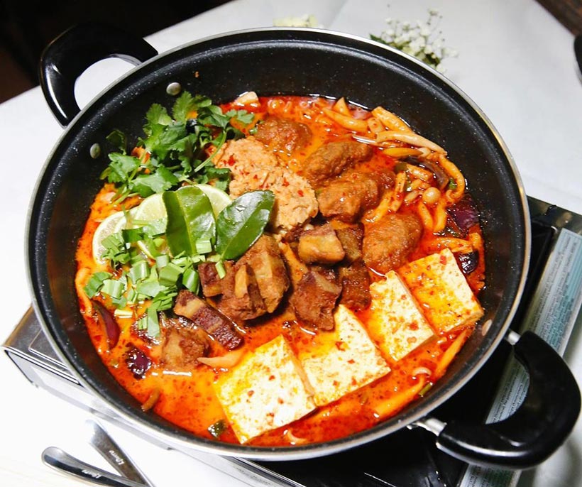 fiery Tom yum soup noodle with vegan crispy pork, Omni crab, Omni mince, firm tofu.