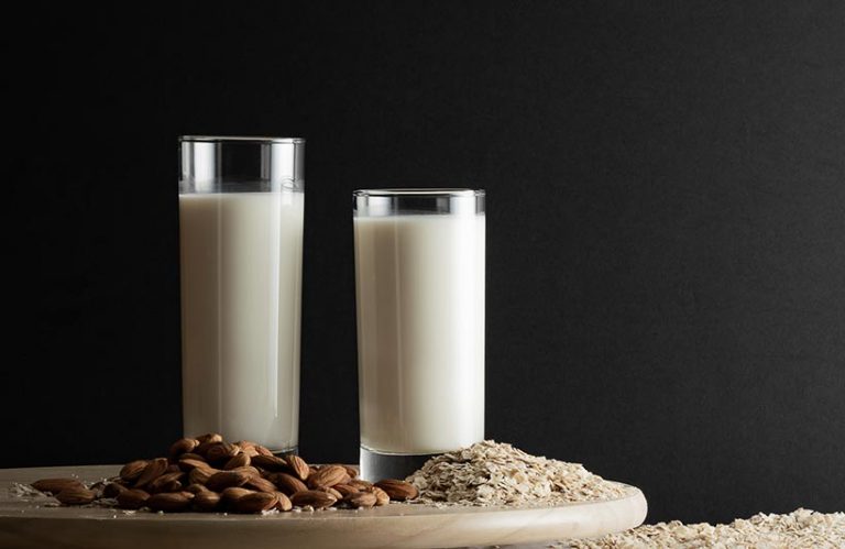 Unsweetened almond milk has less sugar than oat milk but it requires more water to make than oat milk. Photo © Anna Gorbacheva via Getty Images