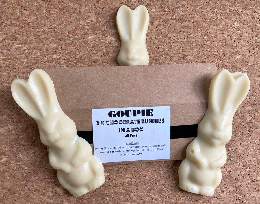 Goupie-three-vegan-White-chocolate-bunnies-sitting-next-to-their-packaging