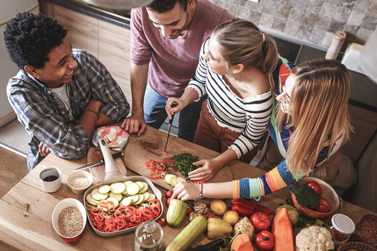 Sharing vegan meals and recipes with friends is a subtle but powerful way to help the animals. Photo © BalanceFormCreative via Adobe Stock