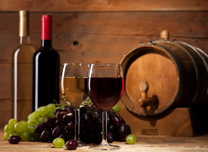 Red and white wine on wooden background