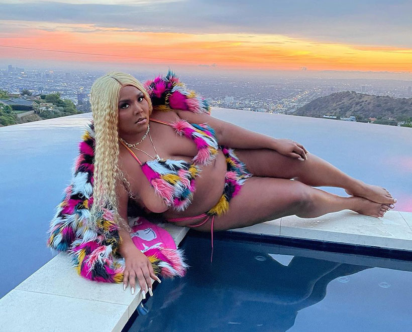 Lizzo lying by the pool in a faux fur bikini 