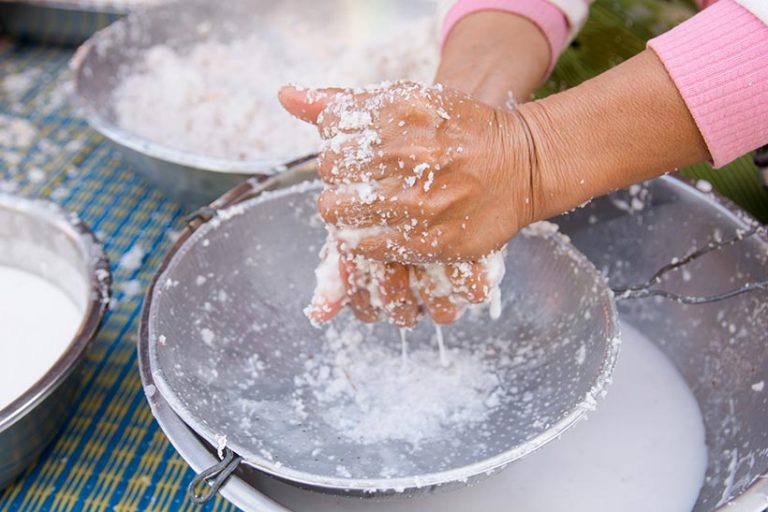 Coconut milk is made by grating coconut flesh and combining it with water. You can even make it yourself by hand by squeezing the mature flesh until the milk runs out.  Image credit: Tevarak via Getty Images