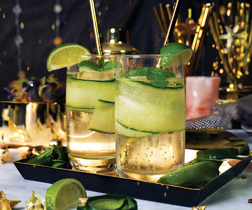 gin and tonic with cucumber and lime in festive glasses