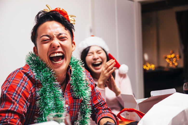 People laughing in Christmas pyjamas 