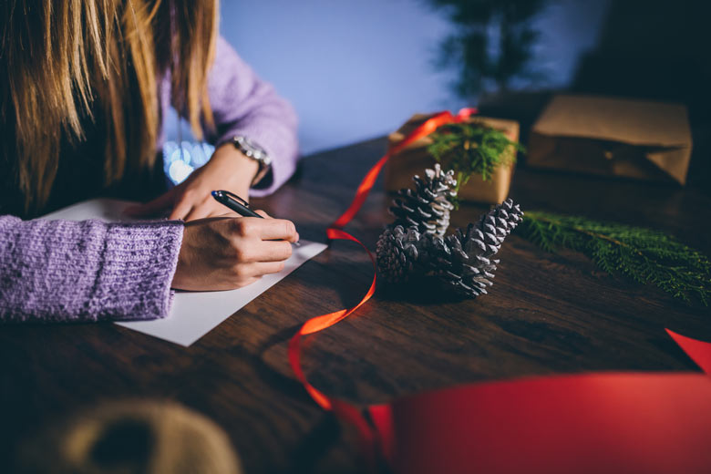 Person writing a list at Christmas