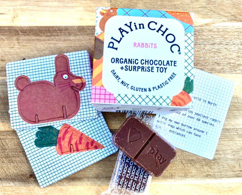 Play-in-Choc-Rabbit-Easter-box-with-contents-spread-out,-including-blocks-of-vegan-chocolate-and-cardboard-rabbit-figure