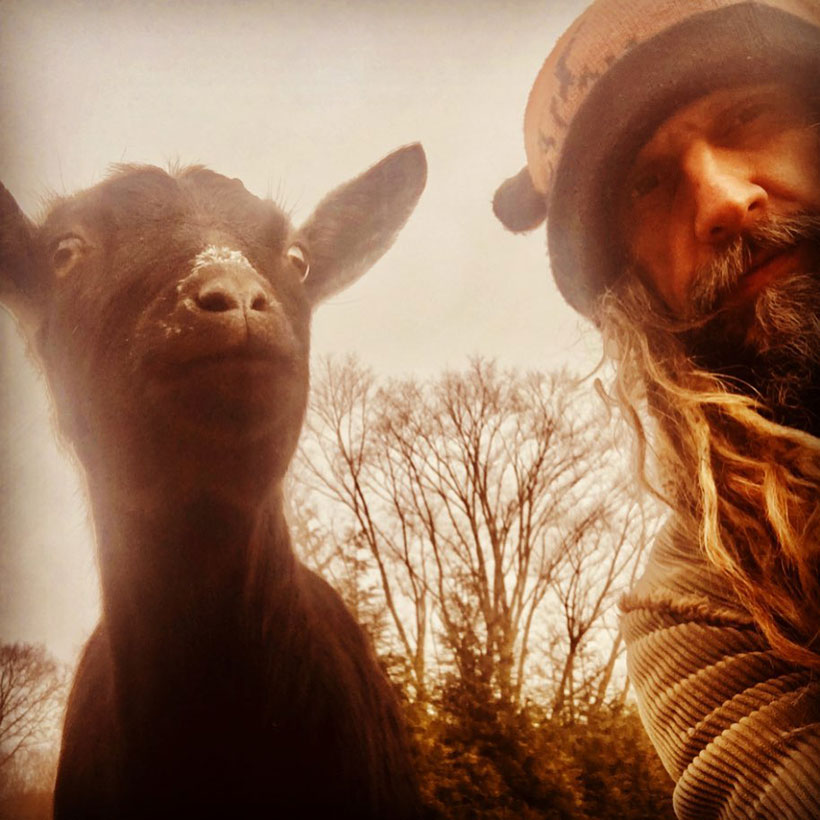 Rob Zombie poses with a goat 