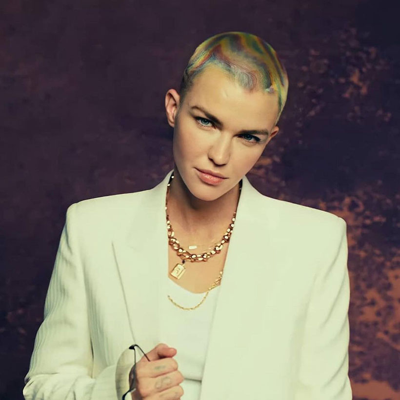 Ruby Rose wearing a white suit with multi-coloured hair 