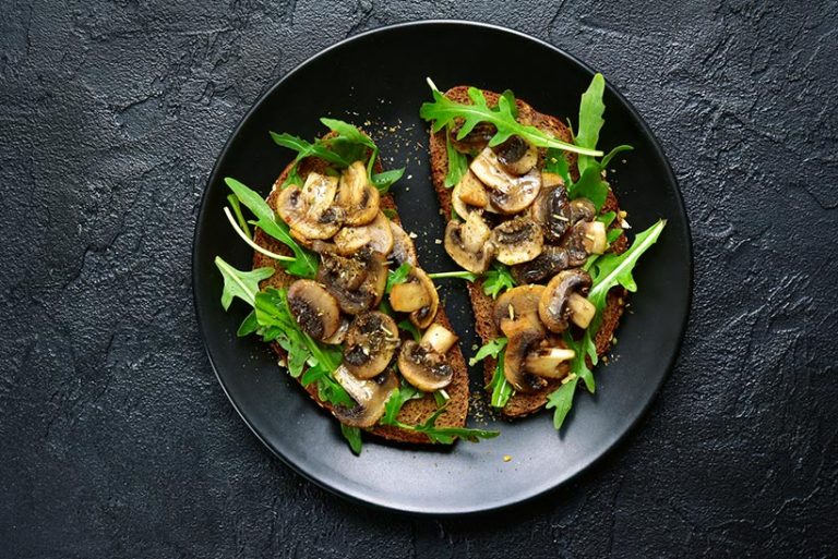 Rye toast with sauteed mushrooms is a delicious way to start your day when following a vegan diet. 