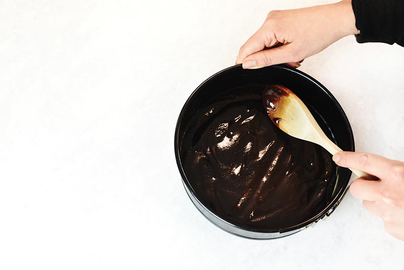 spreading caramel on bottom of cake pan