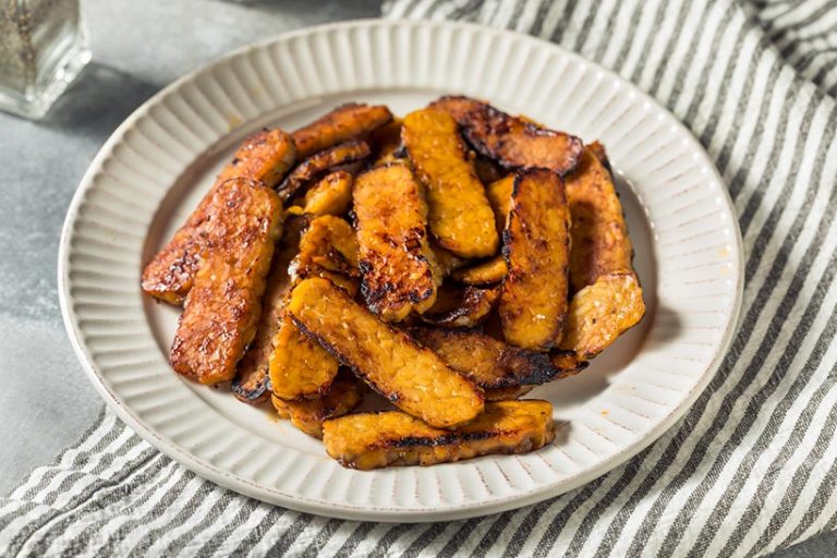 Tempeh bacon has the sweet, salty and smoky appeal of bacon and is a good source of plant-based protein. Image credit: bhofack2 via Getty Images