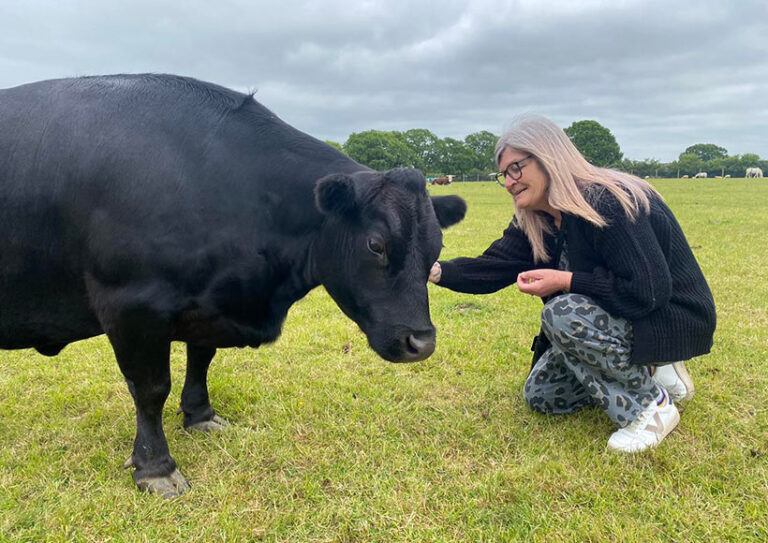 The Retreat supporter Jill meets her namesake Jill the cow. Photo © The Retreat Animal Rescue Farm via Facebook