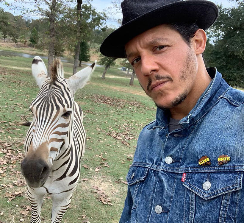 vegan celebrities - Theo Rossi takes a selfie with a zebra 