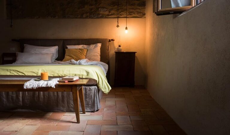 The stylish bedrooms are steeped in rustic charm, with vintage furnishings, hand-sewn linens, and terracotta tiles providing a cosy backdrop to your stay. Photo © Vegan Agrivilla i pini