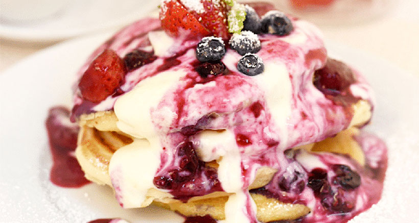 Fluffy American-Style Pancake Stack with Berry, Mint and Lime Compote