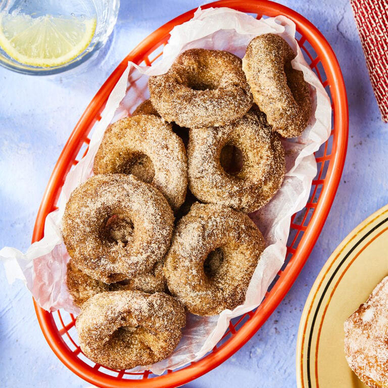 Baked vegan apple doughnuts in a red basket