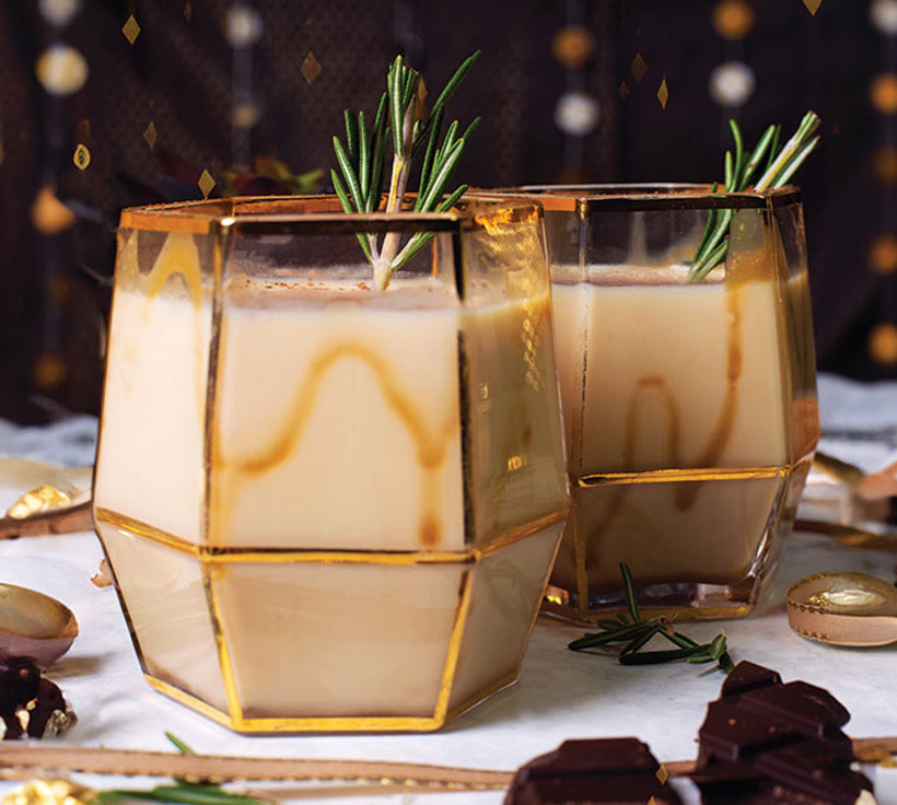 creamy white russian vegan cocktails in gold glasses on festive party table