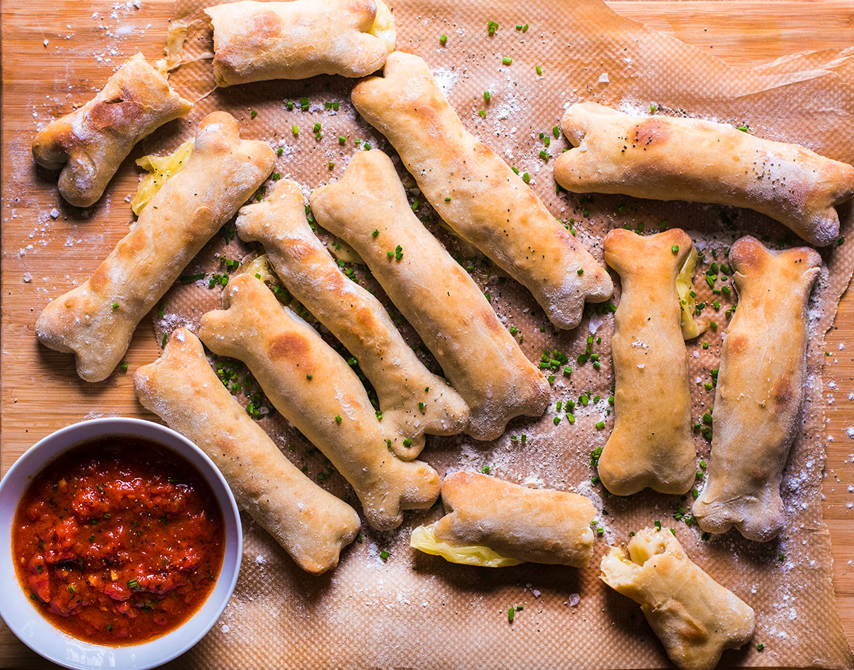 These eerie Cheesy Breadstick Bones with Marinara Dip make spooktacular Halloween party snacks