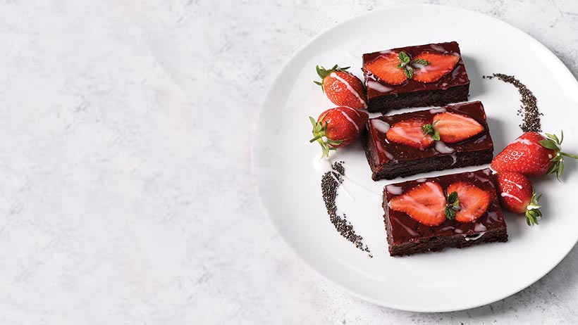 Vegan Chocolate Chia Brownies topped with strawberries 