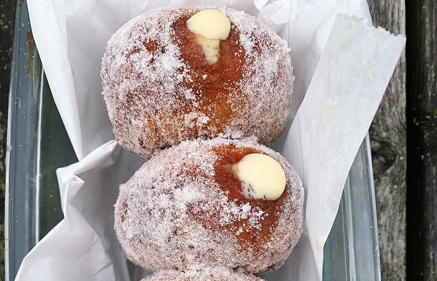 Vegan custard doughnuts in baking paper