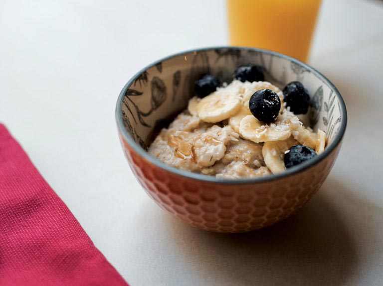 Start your day with a bowl of porridge topped with blueberries and bananas. 