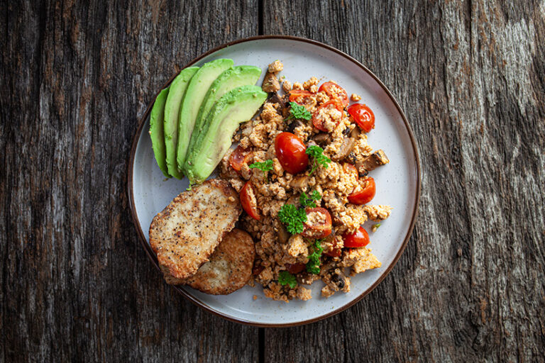 Scrambled tofu is a healthy alternative to eggs, especially when served with healthy fats and veggies for a nutritional boost. Photo © Michael Dolicke via Getty Images