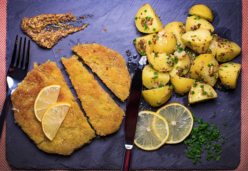 seitan schnitzel with warm potato salad on slate