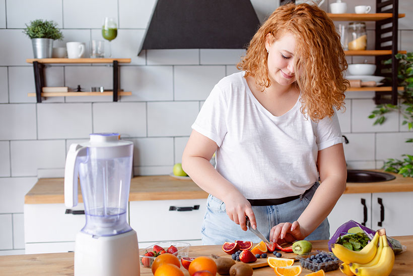 woman preparing fruit for healthy vegan meal plan